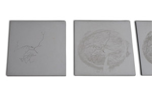 2 of 7 contemporary art wall pieces of square concrete with different reliefs and variance of the image of feminity as conveyed through the placenta.