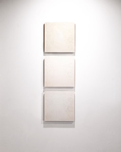 Modern wall art: feminine design shown through relief juxtaposed on concrete tile.