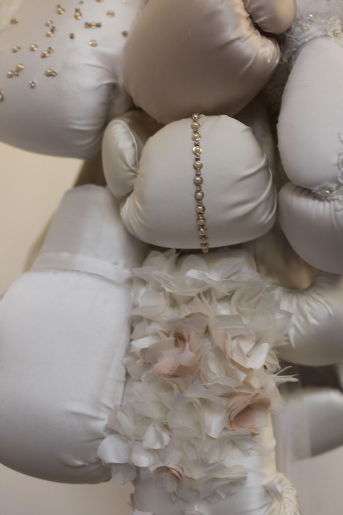 Boxing gloves marry wedding dresses in artist Zoe Buckman's sculpture