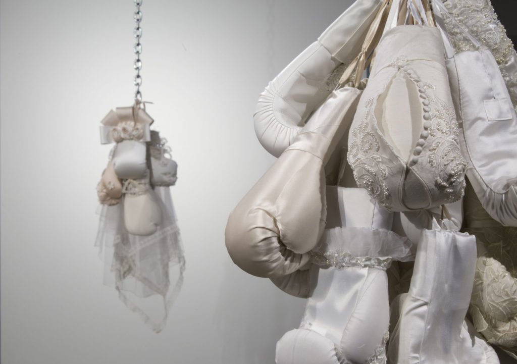 Punching bags made of wedding dresses as feminist fabric art